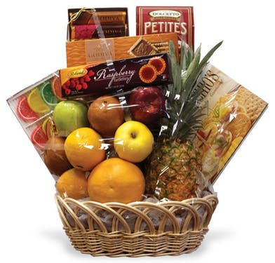 wicker basket with assorted fruit and candies