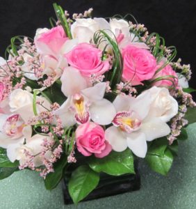 A Contemporary cube arrangement, with Cymbidium orchids and roses.