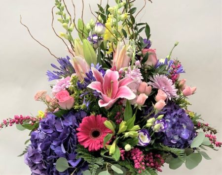 Beautiful assortment of Spring Color and Flowers careful arranged in a vase.
