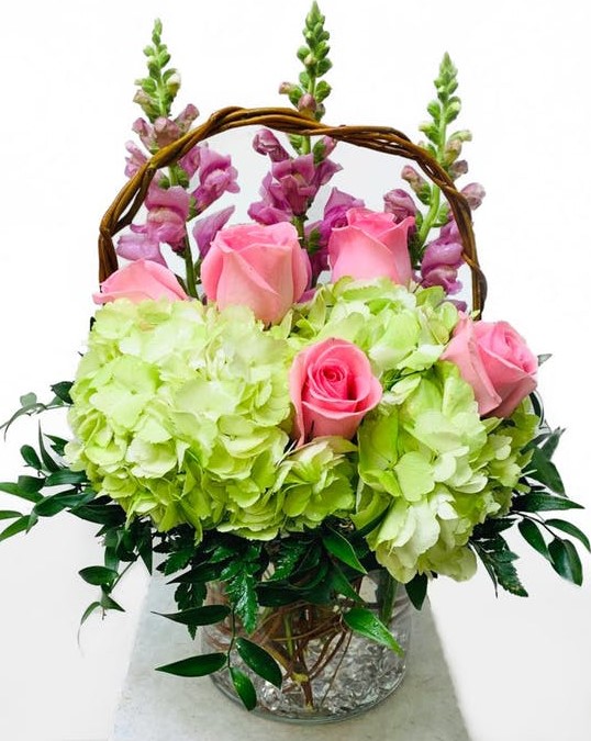 This fun pastel design of pink roses, purple stock and green hydrangeas in a glass cylinder vase is the perfect gift for spring! Put a smile on someone's face with this cheerful choice.